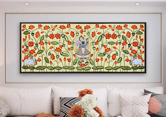 Hand-painted Pichwai painting of Shrinathji with cows and lotus flowers on a living room wall
